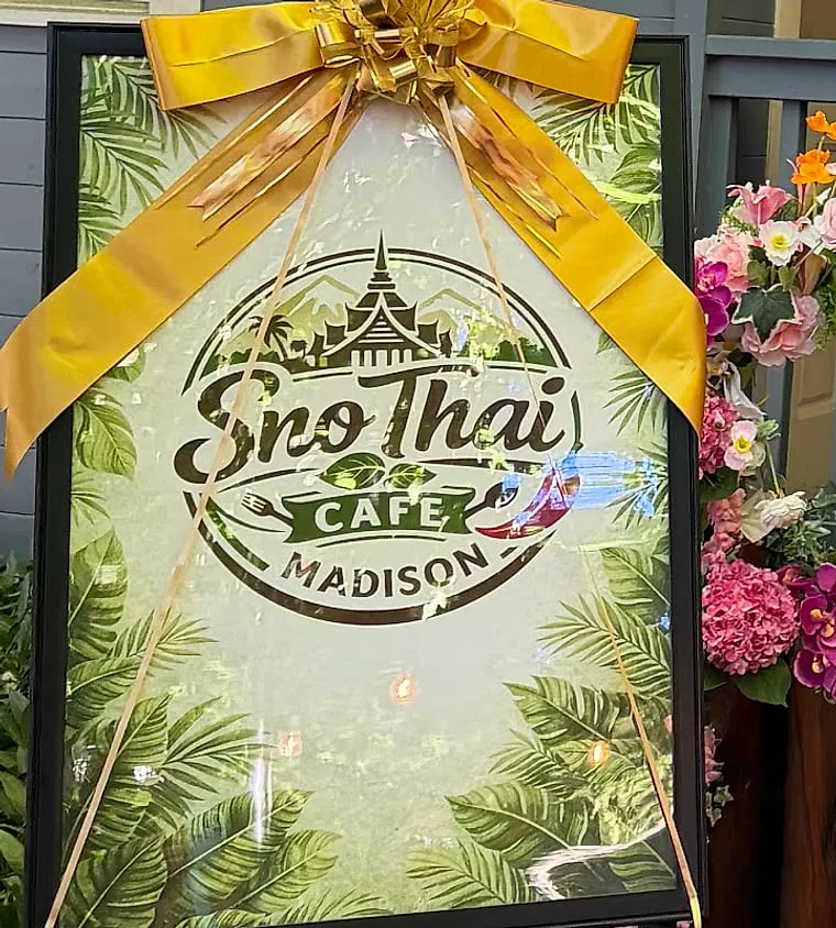 The Sno Thai Cafe Madison sign on the sidewalk out front
